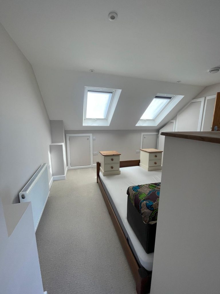 Loft bedroom painting completed in BS6 Bristol with clean grey walls and white trim