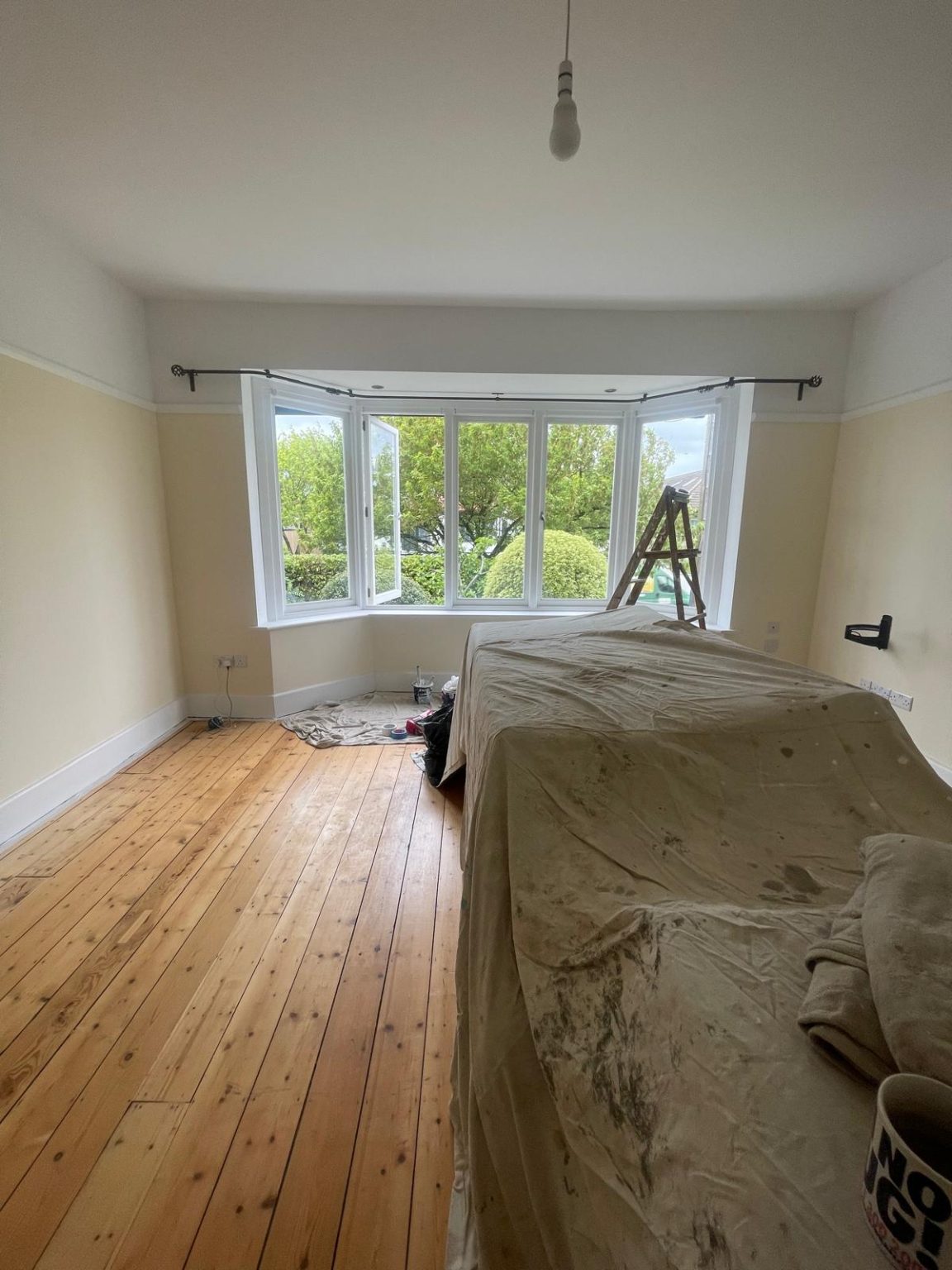 Home 54 Bedroom painting preparation in Kellaway Avenue BS6 Bristol with furniture covered and bay window area ready for decorating